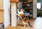 A calico cat scratching a scratching post
