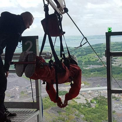 person getting ready for zipwire challenge