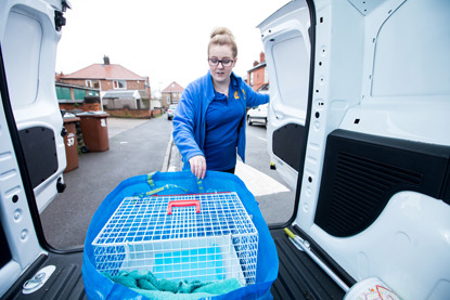 Cats Protection volunteer putting cat trap in back of a van