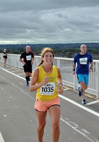 woman running in Cats Protection vest