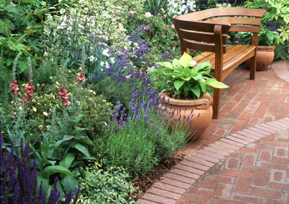 Informal garden flower beds and paving