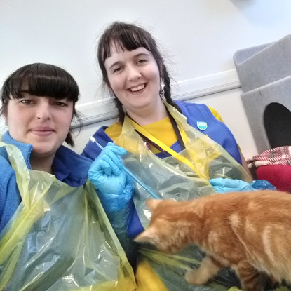 two women in cats protection t-shirts with ginger cat