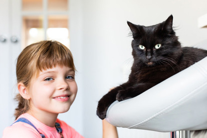 young girl with black cat