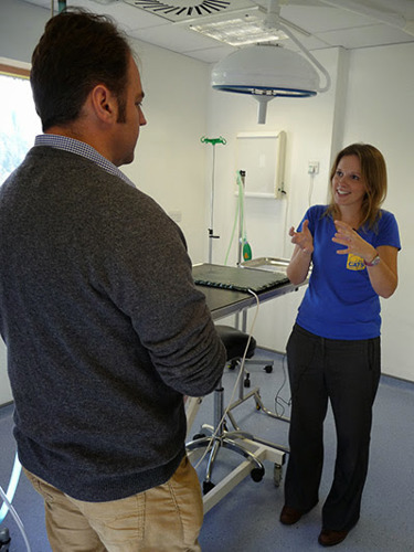 Man talking to woman in vet surgery