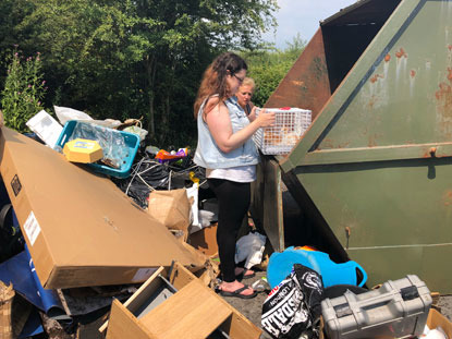 women rescuing kittens from skip