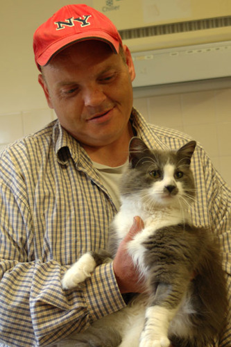 New owner Shane holding cat Baby