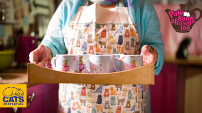 Pawsome Afternoon Tea person holding tray of mugs