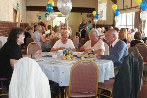 People at anniversary celebration with balloons