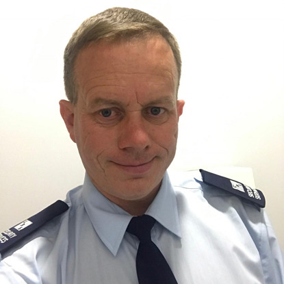 short-haired blonde man wearing security guard uniform