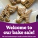 Gingerbread biscuits decorated like cats with text saying 'Welcome to our bake sale! We are fundraising to make a better life for cats'