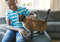 Young boy stroking a brown cat